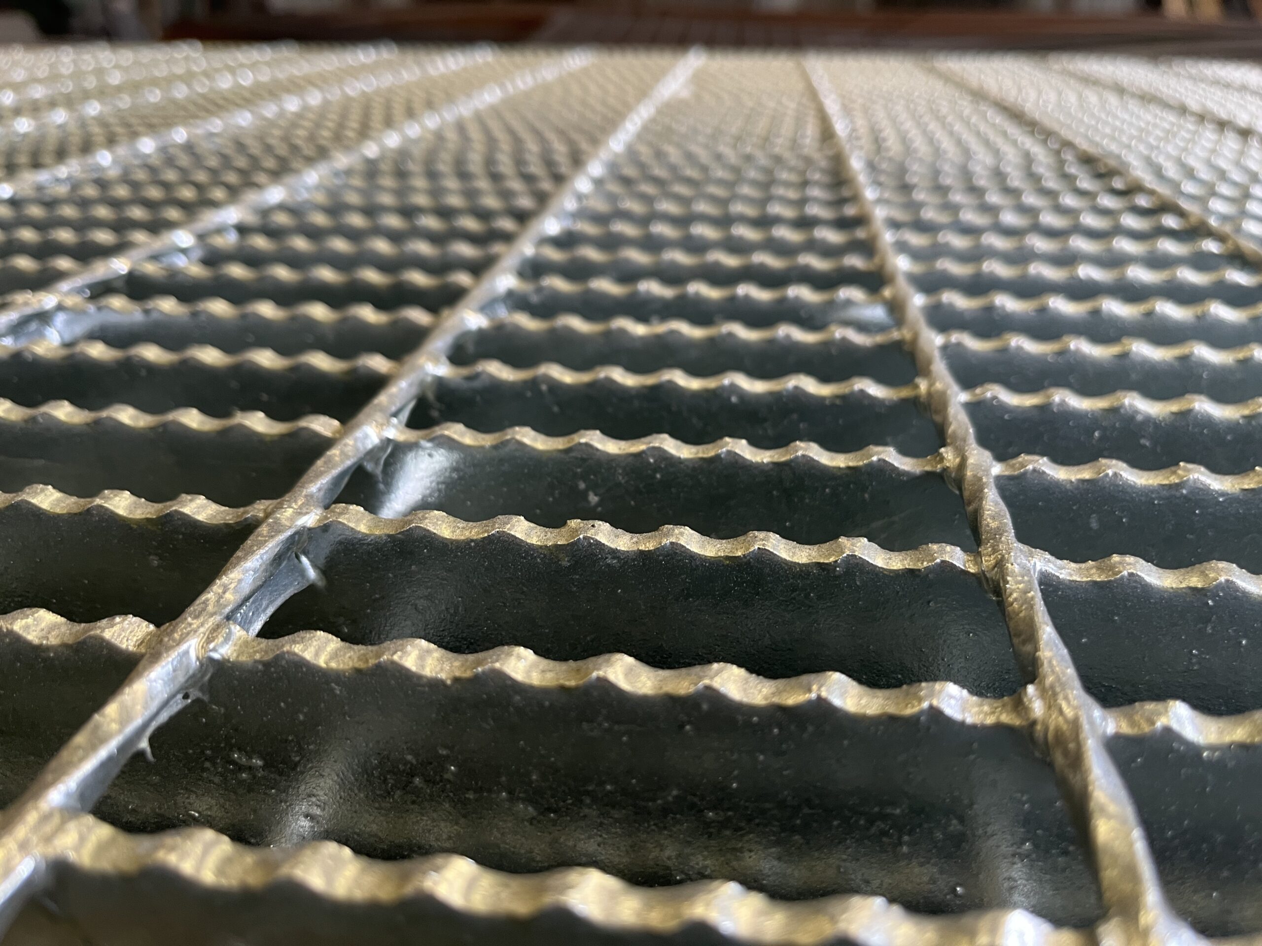 Close-up of heavy duty steel grating bearing bars showing thick construction
